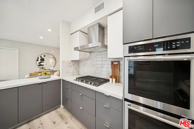 a kitchen with stainless steel appliances granite countertop a stove and a microwave