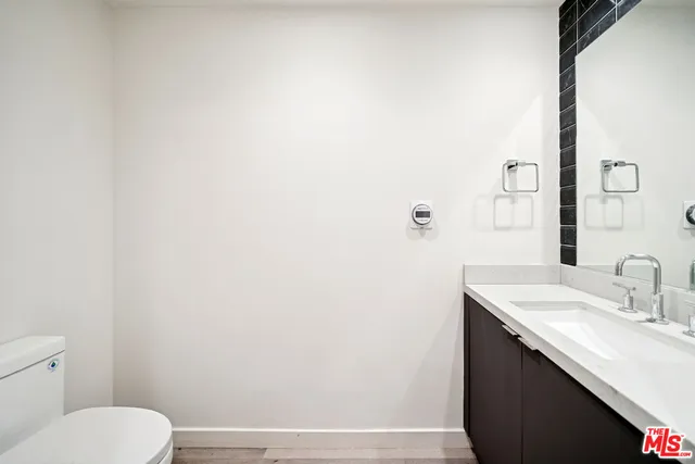 a bathroom with a sink a toilet and mirror