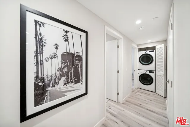 a view of a hallway with wooden floor and windows