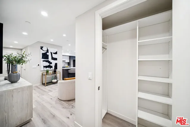 a kitchen with a refrigerator and potted plant