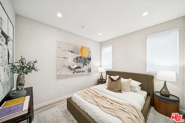 a bedroom with a bed and a potted plant