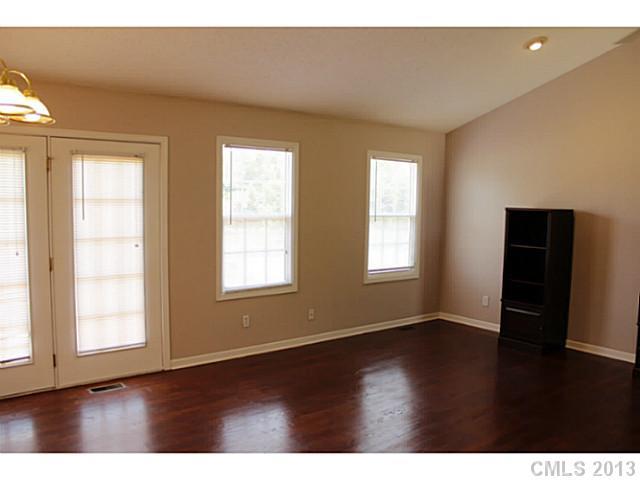 1525 West Ridge Road Salisbury, NC 28147 - Photo 3 of 16 an empty room with wooden floor and windows