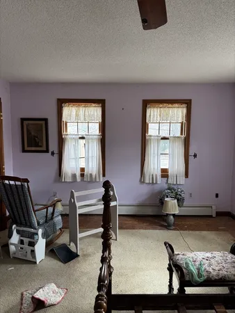 a living room with furniture gym equipment and a window