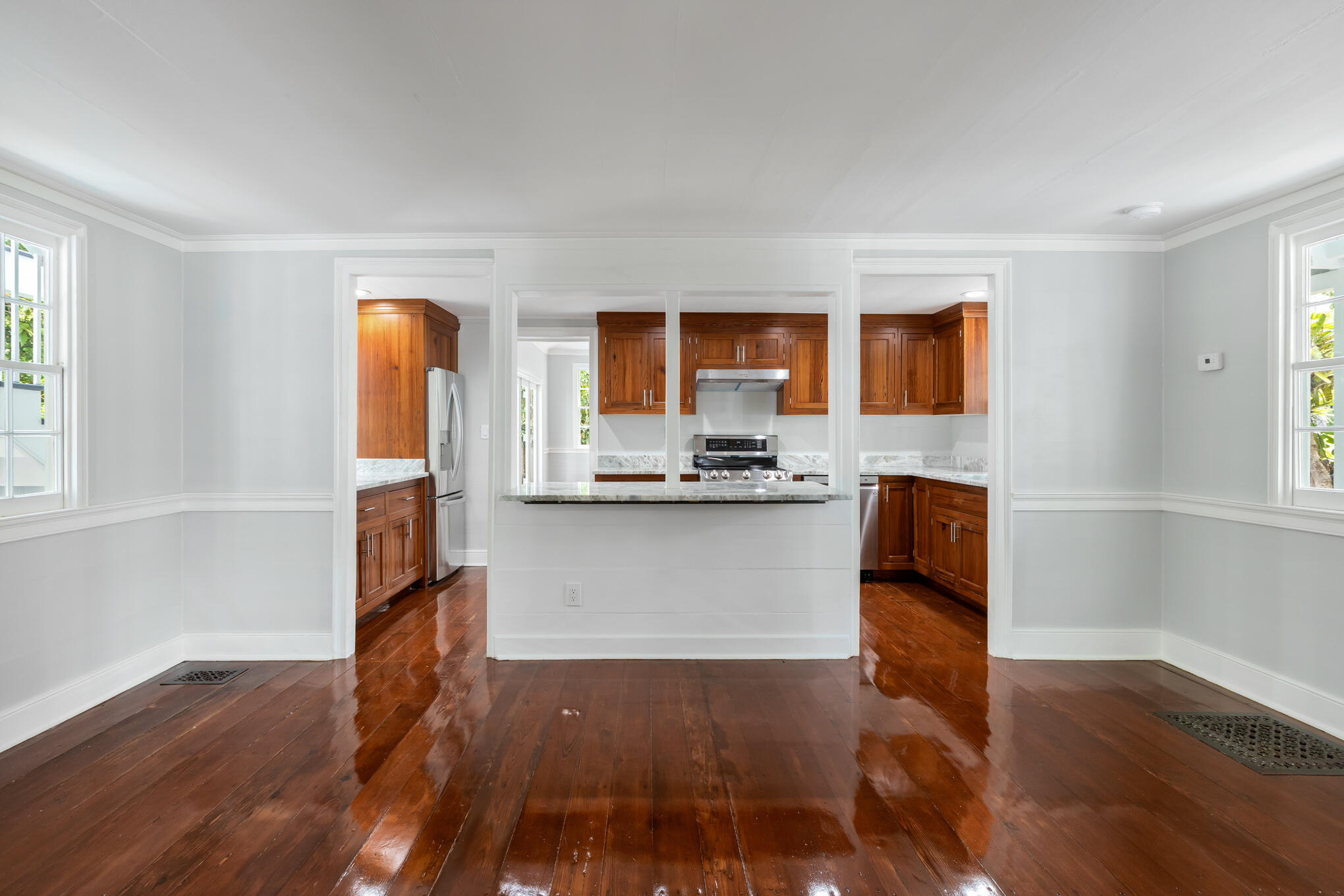 a kitchen with stainless steel appliances granite countertop a stove a sink and a refrigerator