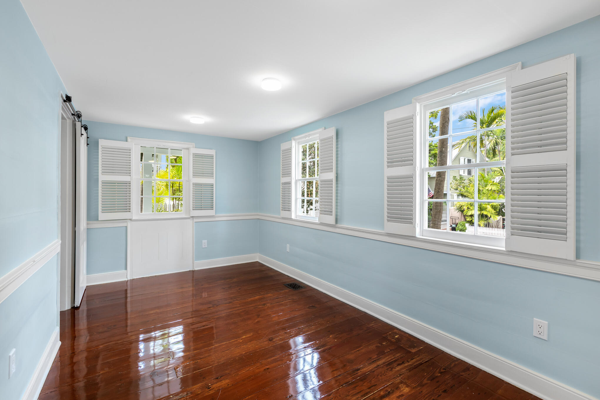 408 William Street Key West, FL 33040 - Photo 11 of 58 a view of empty room with wooden floor and fan