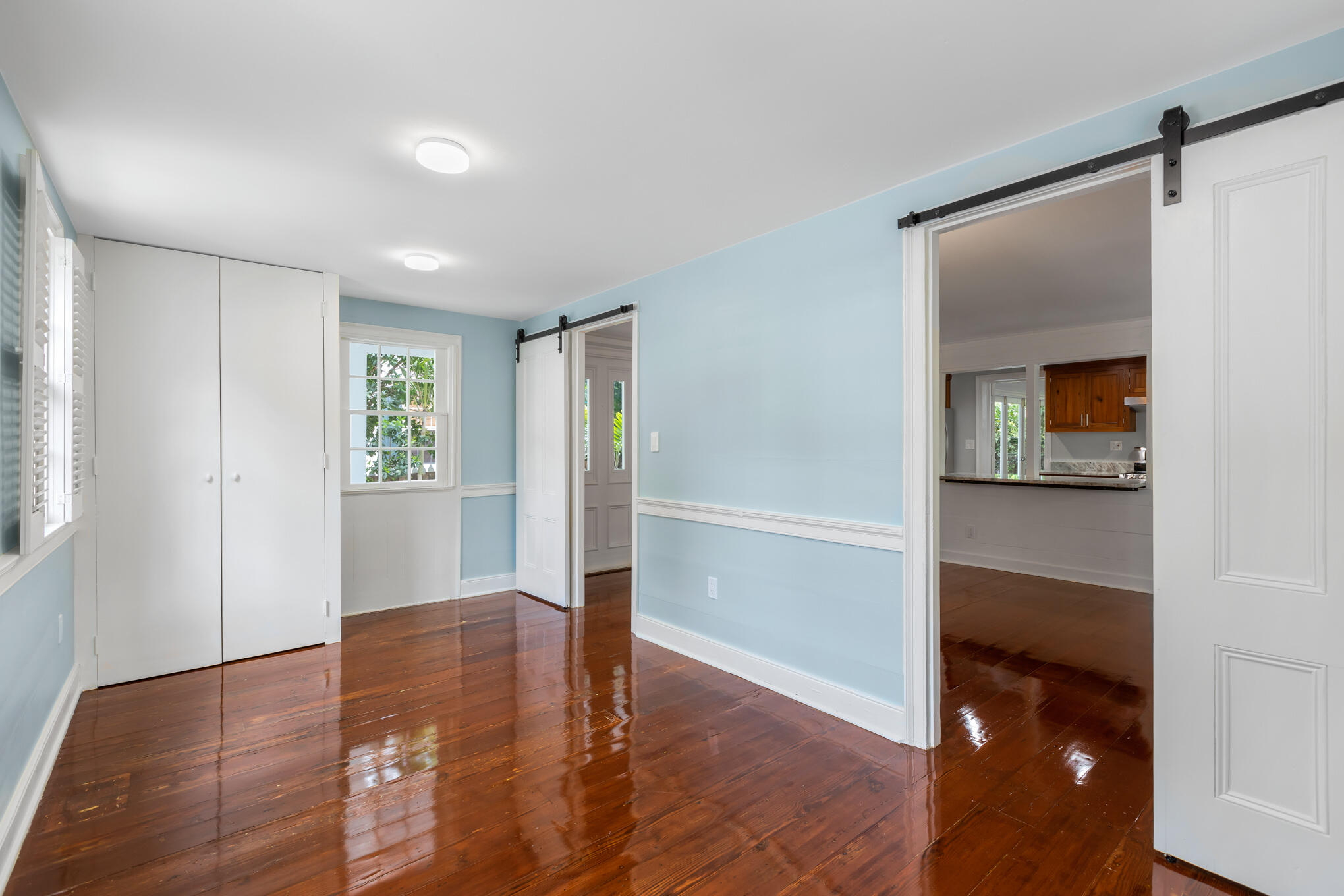 408 William Street Key West, FL 33040 - Photo 13 of 58 a view of an empty room with wooden floor and a window