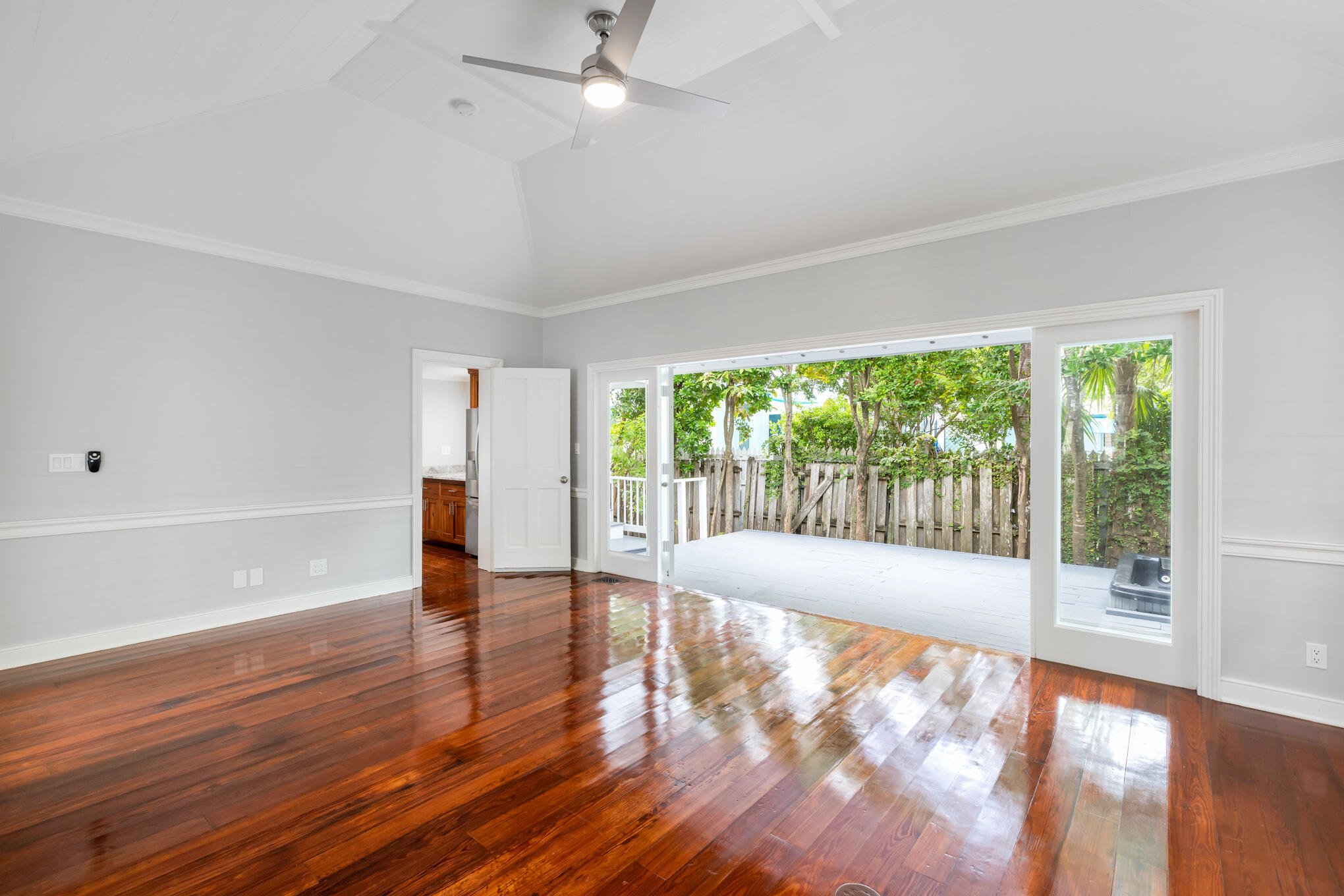 408 William Street Key West, FL 33040 - Photo 16 of 58 a view of an empty room with wooden floor and a window