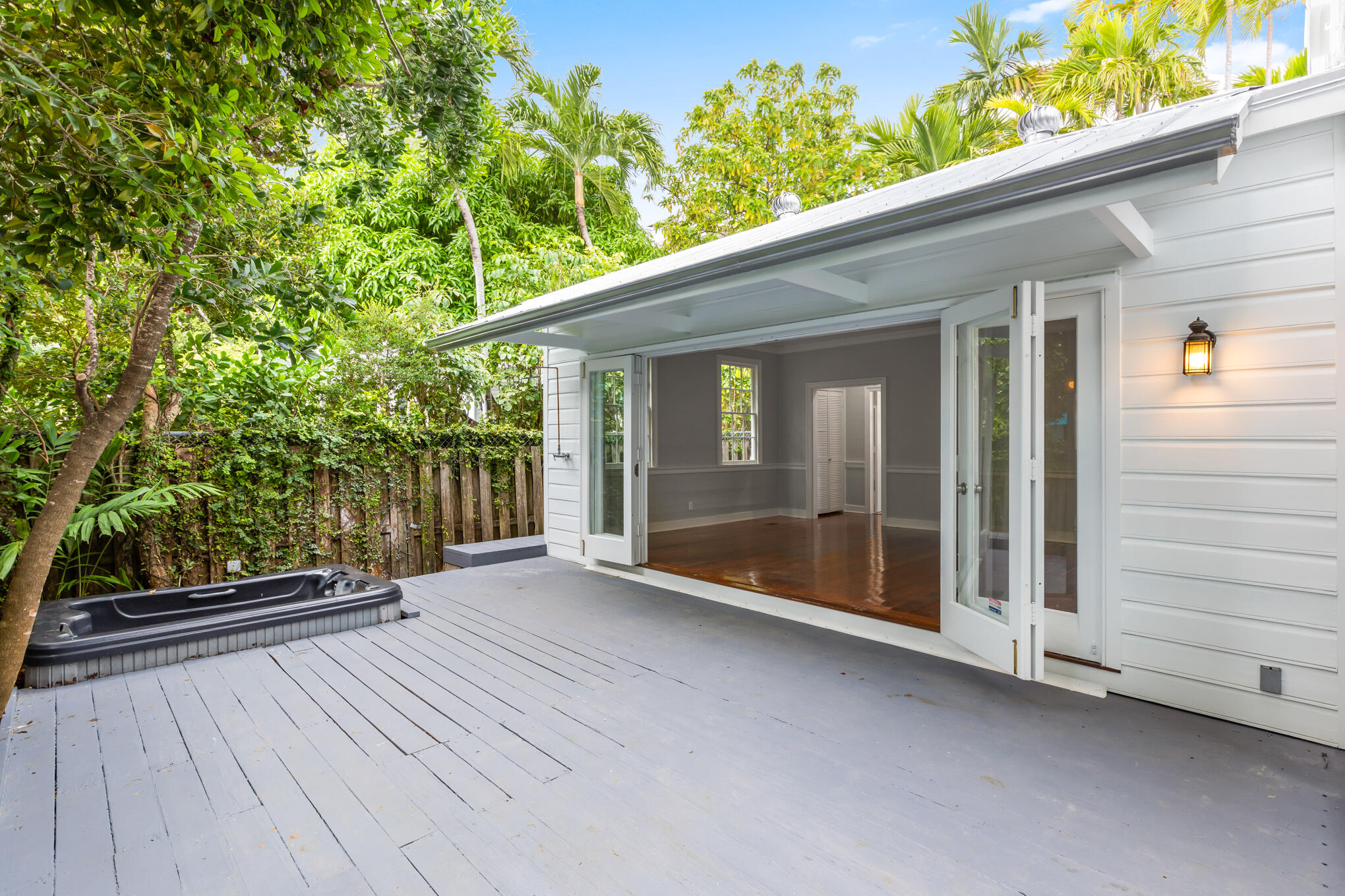 408 William Street Key West, FL 33040 - Photo 17 of 58 a view of backyard with large trees and wooden fence