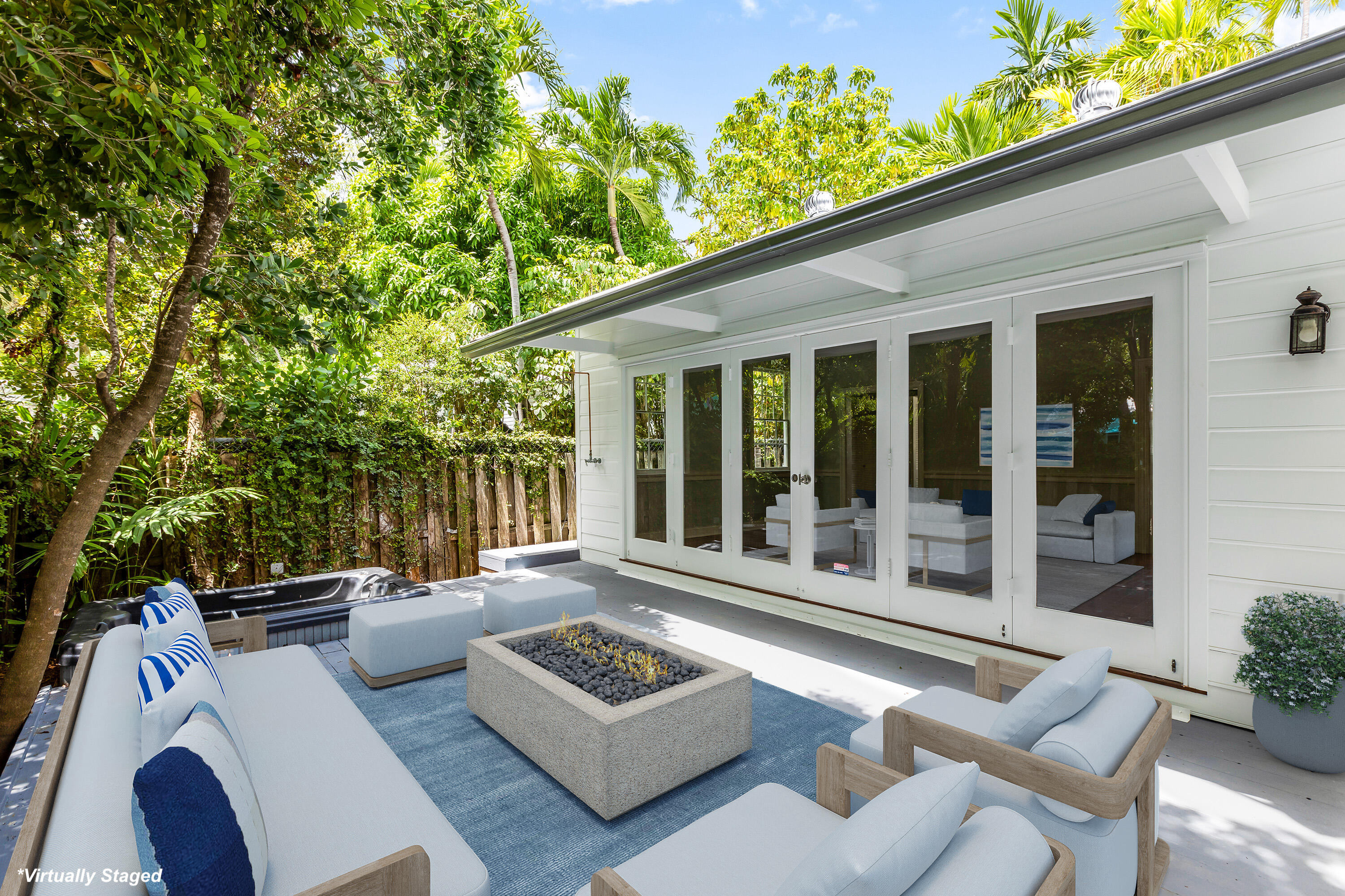 408 William Street Key West, FL 33040 - Photo 18 of 58 a view of a patio with couches table and chairs and potted plants