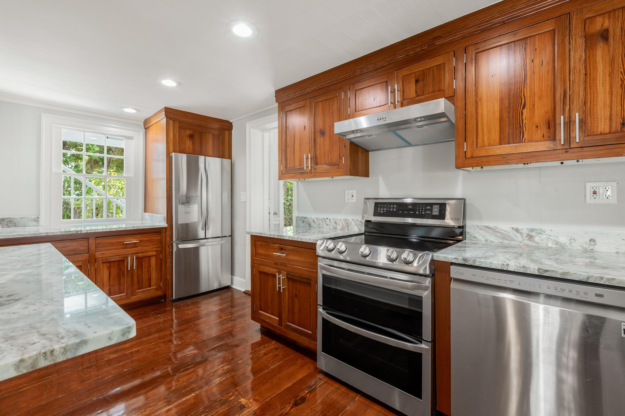 408 William Street Key West, FL 33040 - Photo 2 of 58 a kitchen with stainless steel appliances granite countertop a stove a refrigerator and a microwave