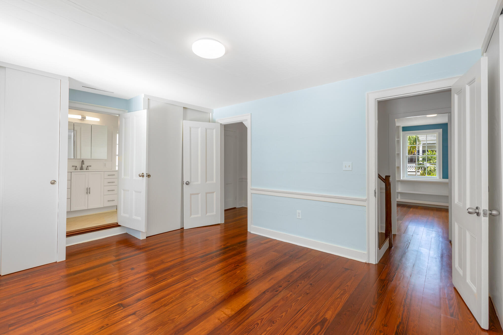 408 William Street Key West, FL 33040 - Photo 26 of 58 an empty room with wooden floor and windows