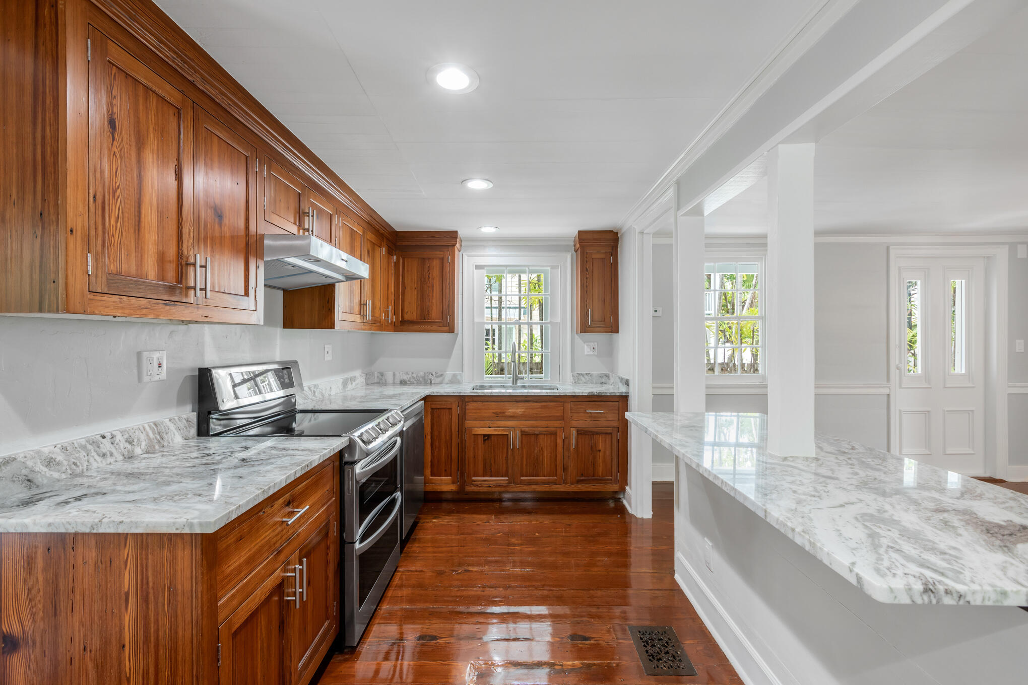 408 William Street Key West, FL 33040 - Photo 3 of 58 a large kitchen with granite countertop a sink and cabinets