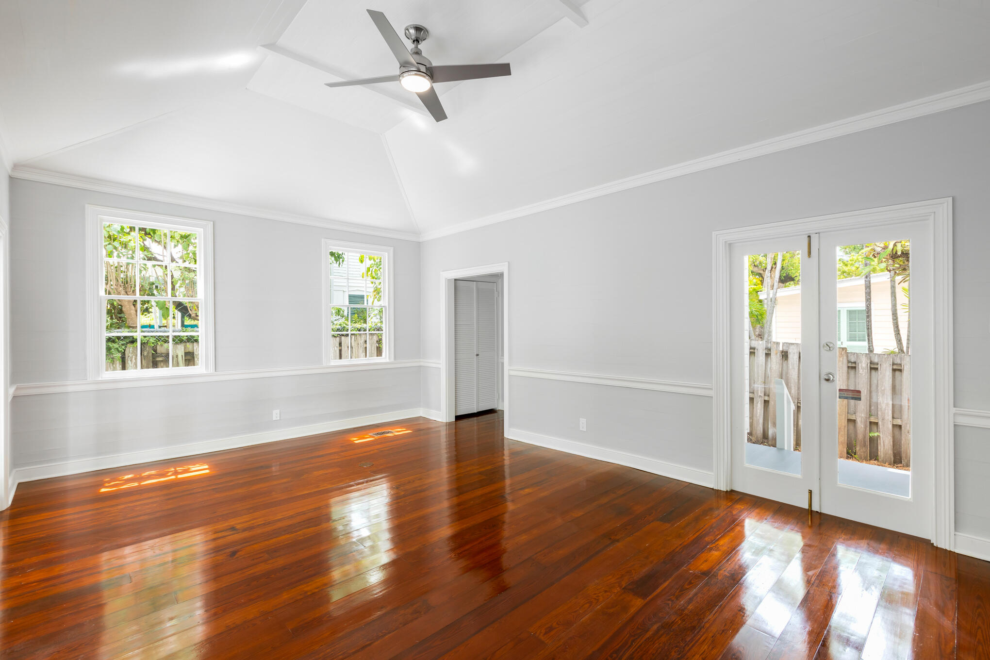 408 William Street Key West, FL 33040 - Photo 32 of 58 a view of an empty room with wooden floor and a window