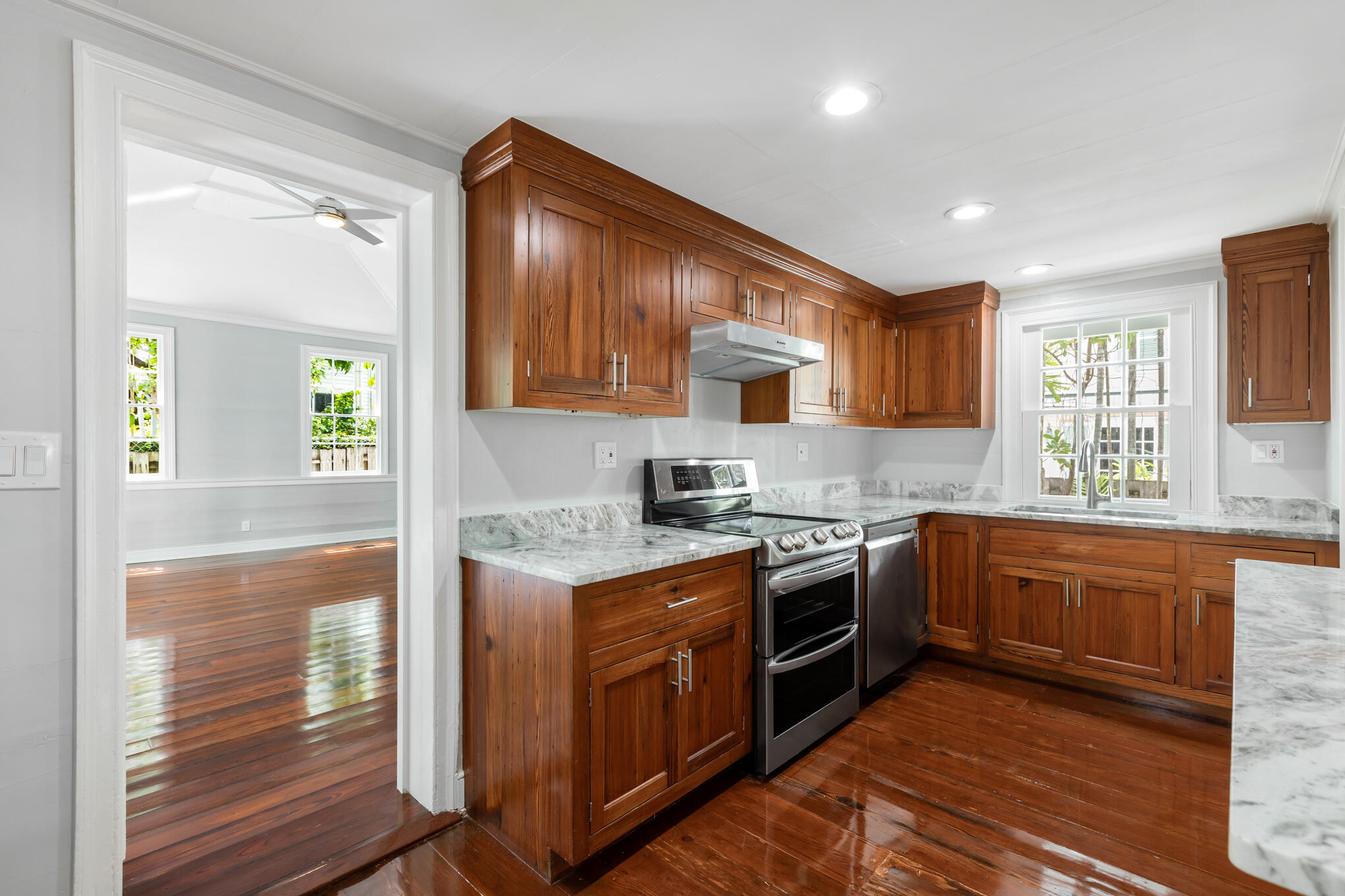 408 William Street Key West, FL 33040 - Photo 37 of 58 a kitchen with stainless steel appliances granite countertop wooden cabinets granite counter tops and a window