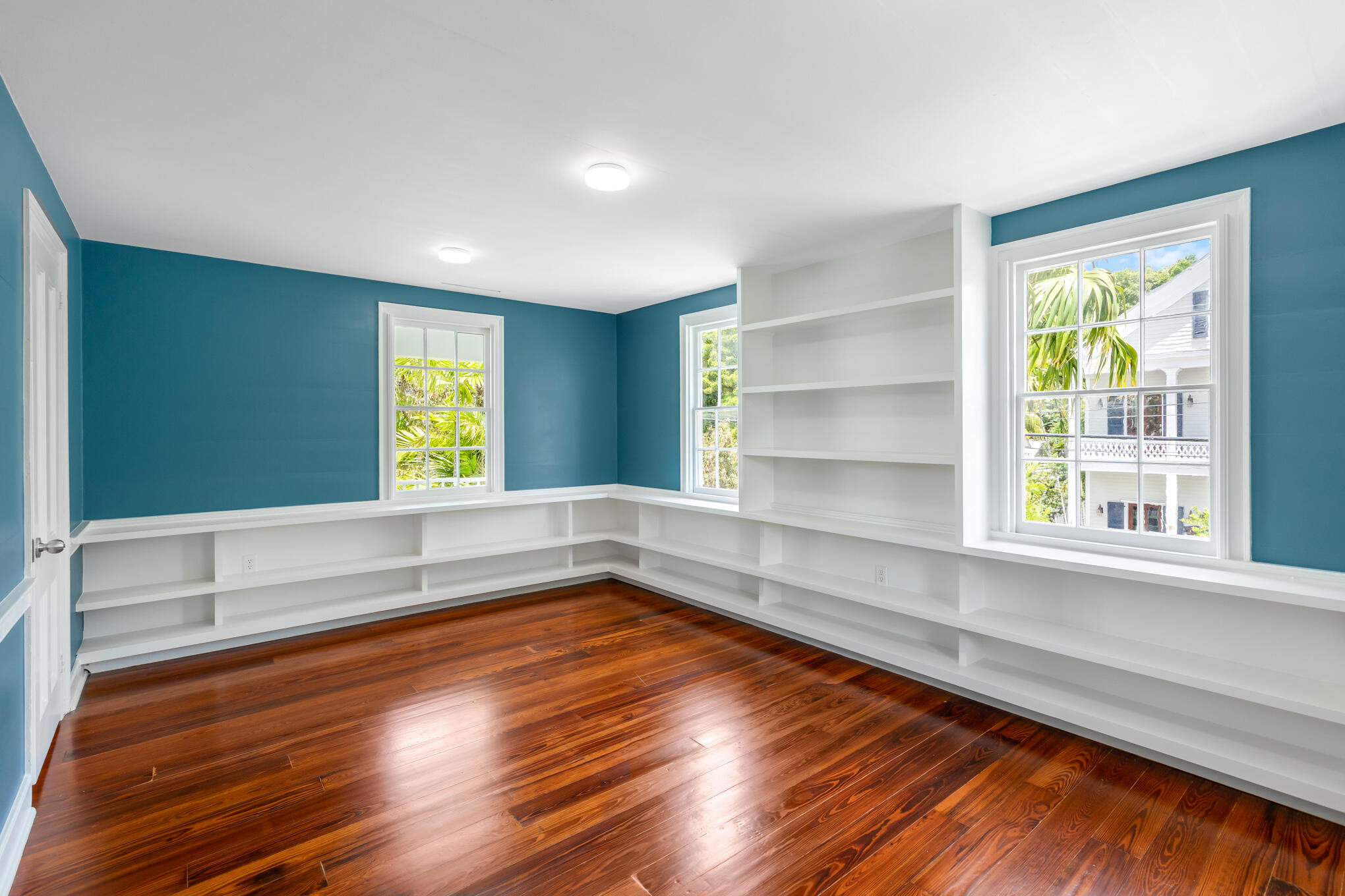 408 William Street Key West, FL 33040 - Photo 48 of 58 a view of an empty room with a window and wooden floor