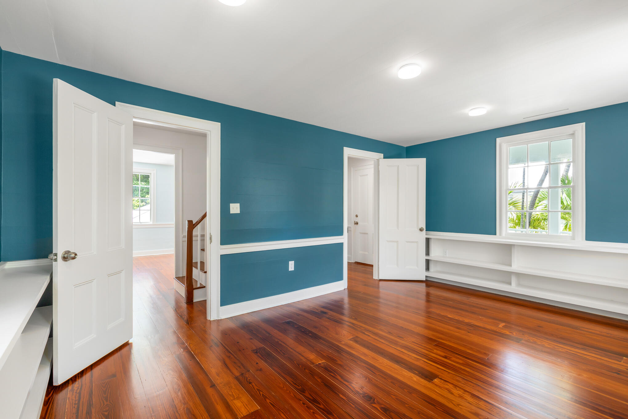408 William Street Key West, FL 33040 - Photo 50 of 58 an empty room with wooden floor and windows