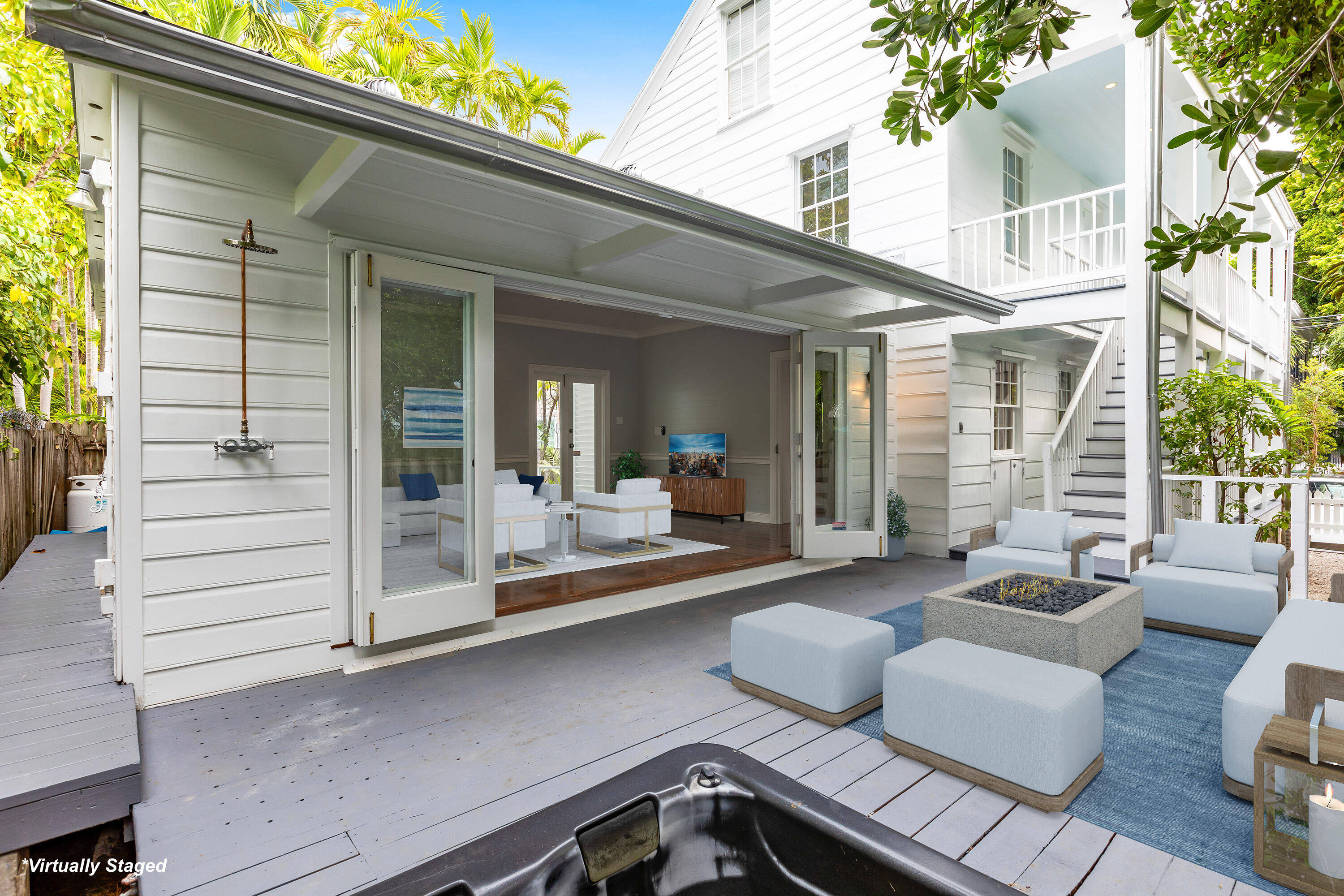 408 William Street Key West, FL 33040 - Photo 6 of 58 a view of a patio with couches table and chairs with wooden floor and fence