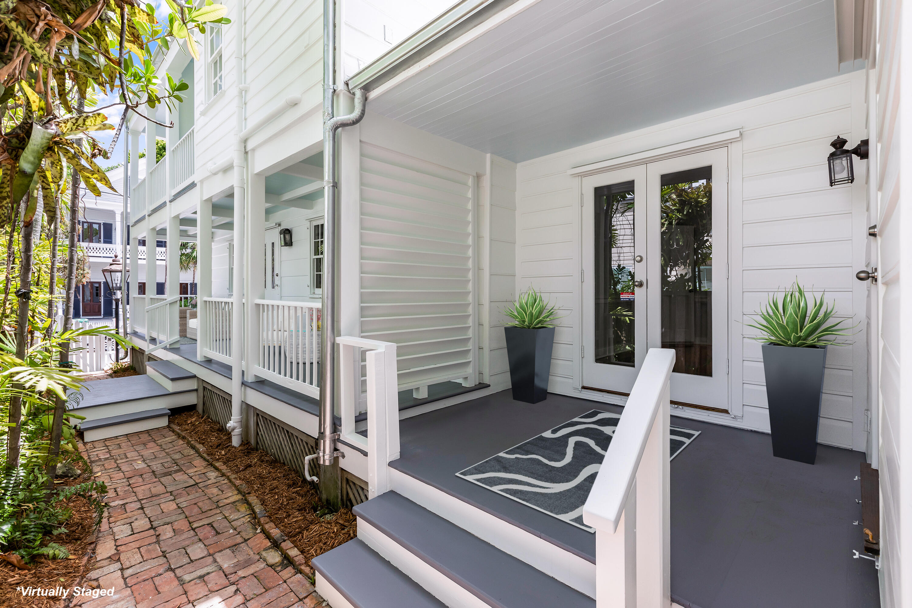 408 William Street Key West, FL 33040 - Photo 8 of 58 a view of a deck with couches and potted plants
