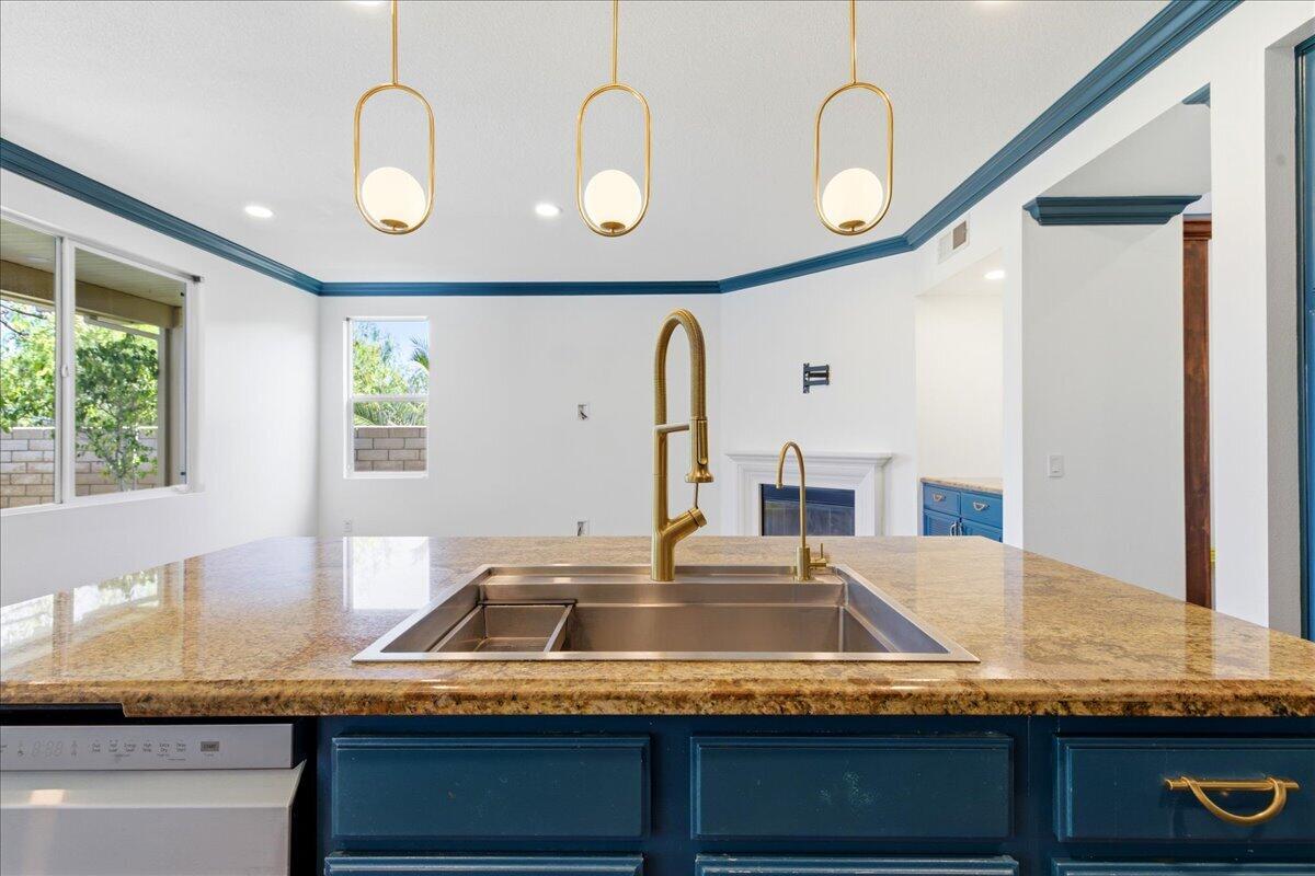 23732 Bella Vista Road Corona, CA 92883 - Photo 12 of 49 a kitchen with kitchen island granite countertop a sink and a wooden floor