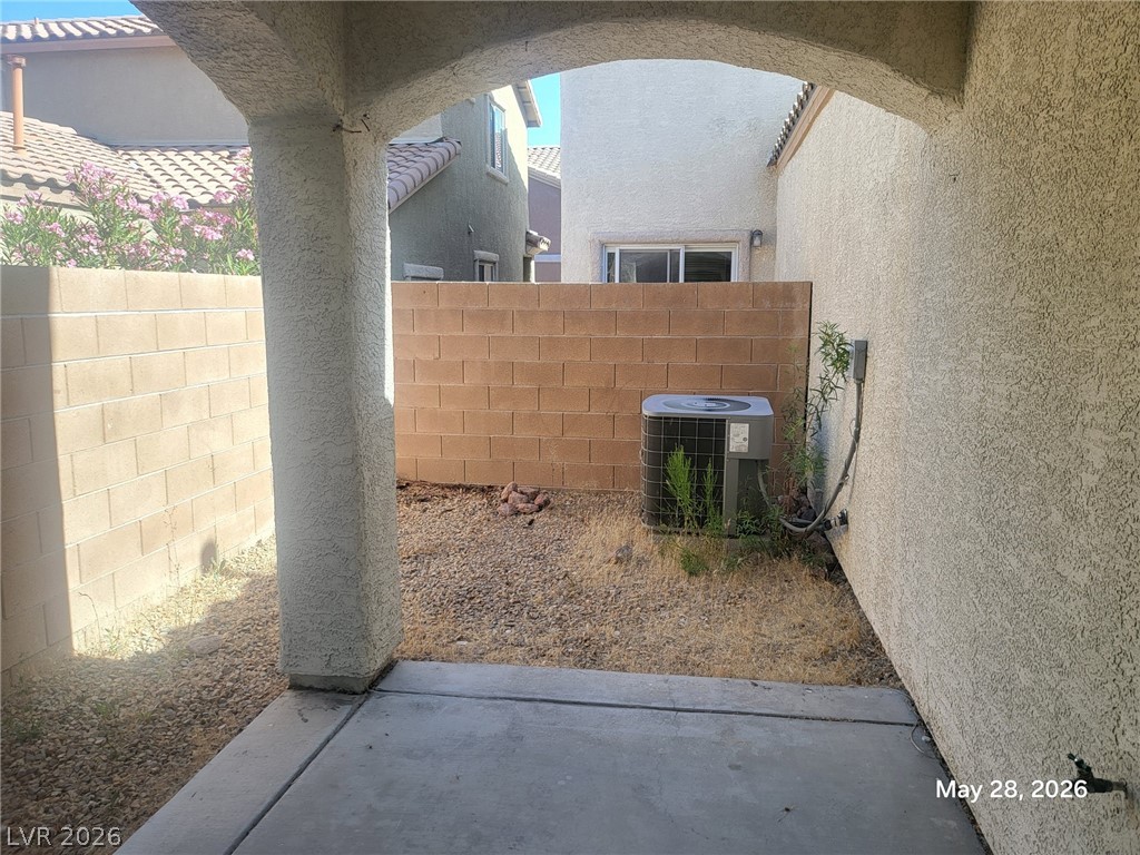 9843 West Overlook Ridge Avenue Las Vegas, NV 89148 - Photo 17 of 19 A private outdoor retreat with a paved patio and textured walls.