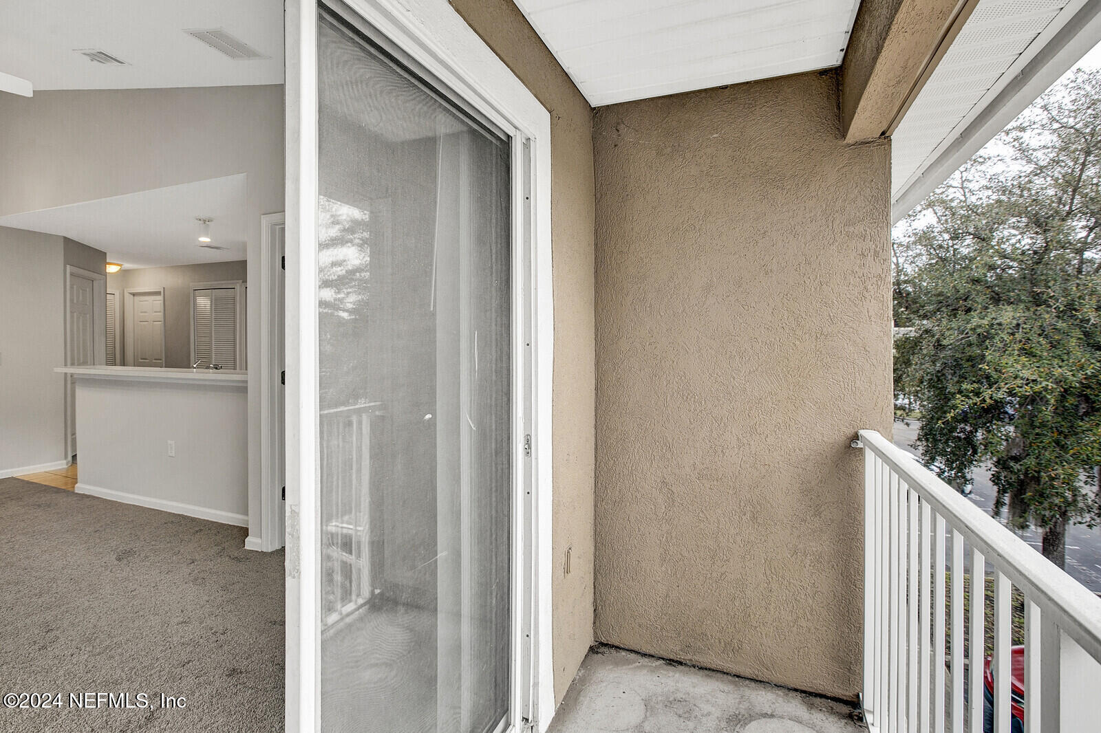 7920 Merrill Road, Unit 1411 Jacksonville, FL 32277 - Photo 15 of 18 a view of a hallway with wooden floor and entryway