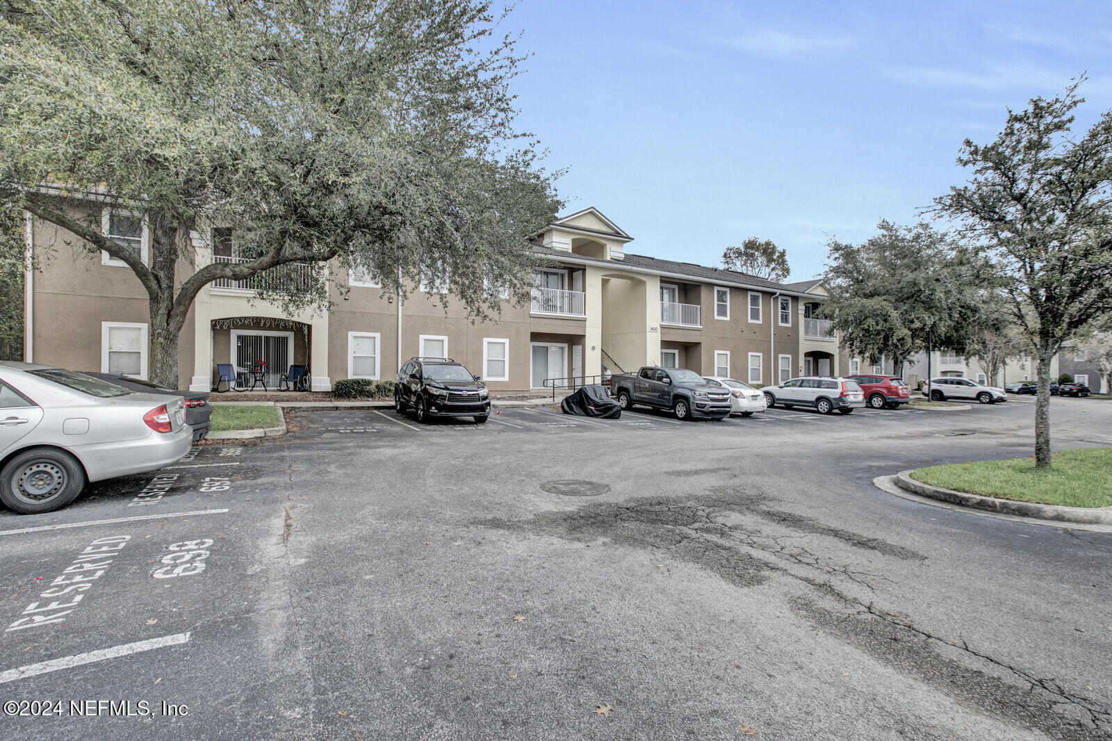 7920 Merrill Road, Unit 1411 Jacksonville, FL 32277 - Photo 16 of 18 a cars parked in front of a house