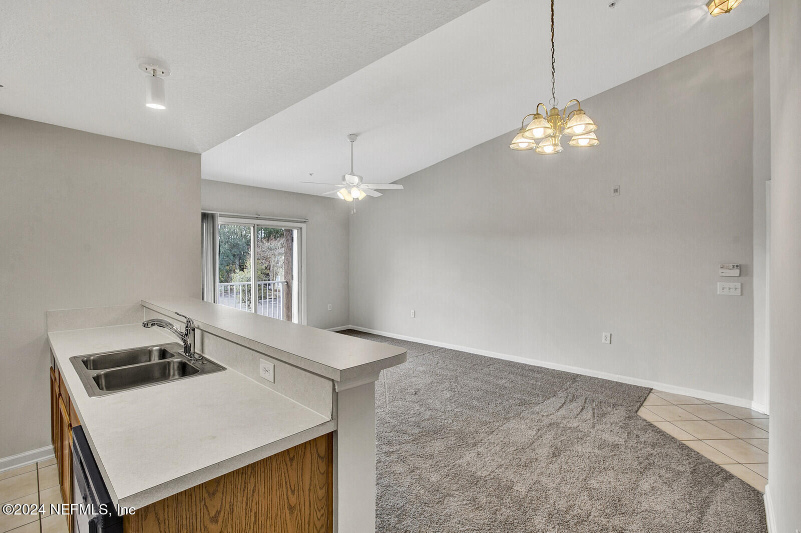 7920 Merrill Road, Unit 1411 Jacksonville, FL 32277 - Photo 3 of 18 a view of a kitchen sink and a stove