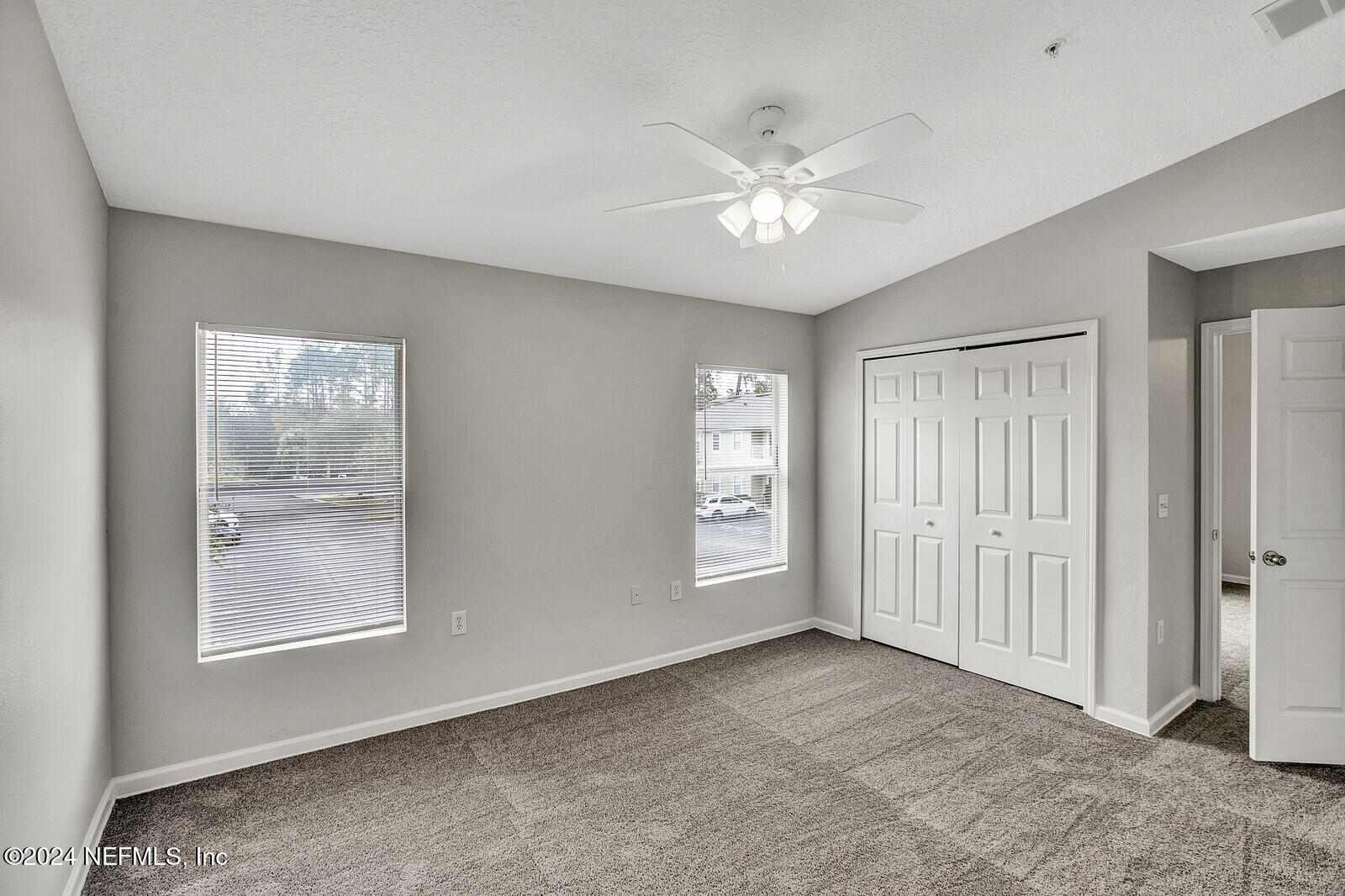 7920 Merrill Road, Unit 1411 Jacksonville, FL 32277 - Photo 7 of 18 wooden floor in an empty room with a window