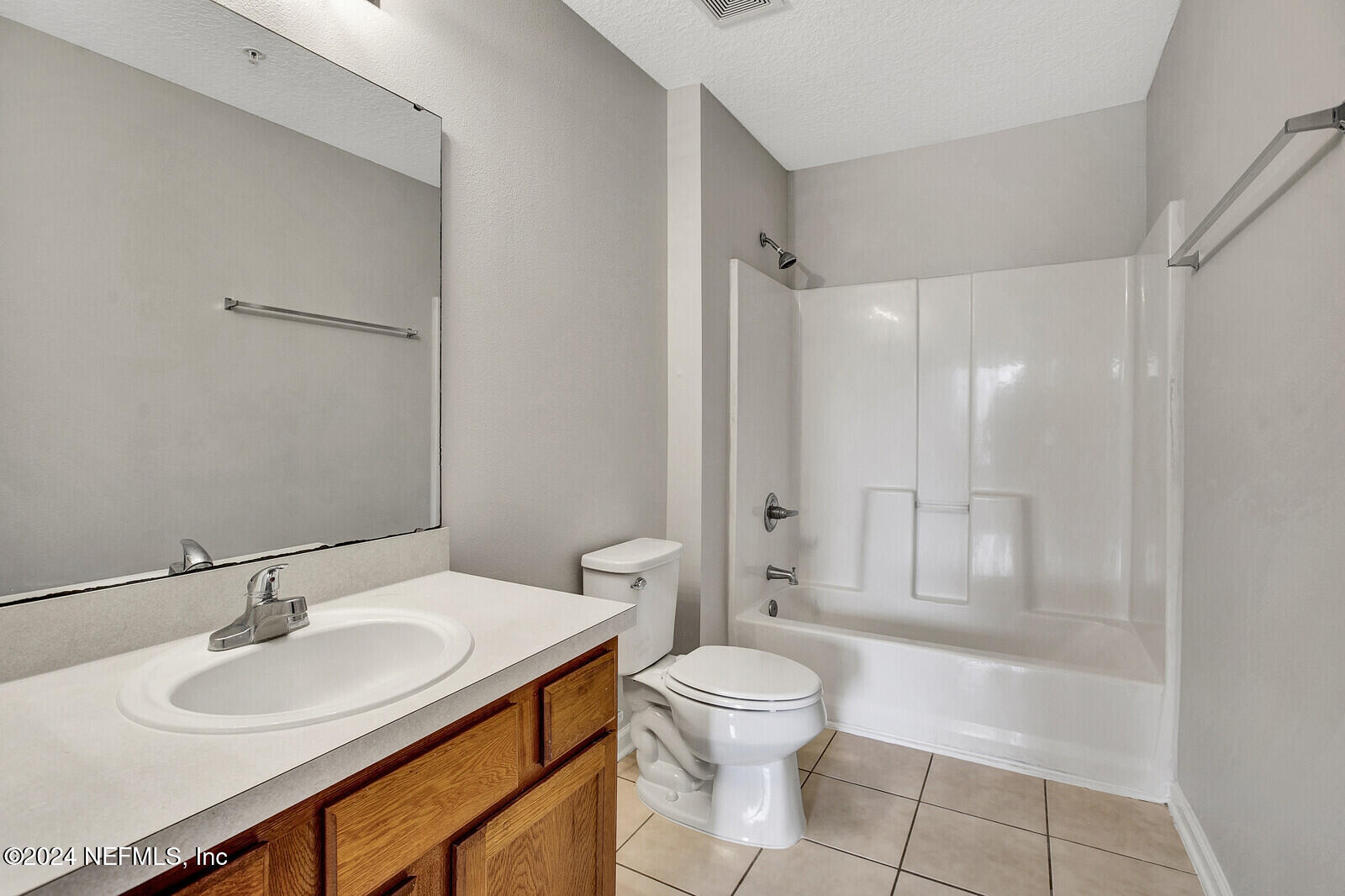 7920 Merrill Road, Unit 1411 Jacksonville, FL 32277 - Photo 9 of 18 a bathroom with a sink toilet a mirror and shower