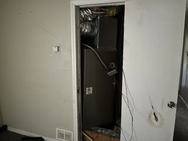 an empty room with windows and closet