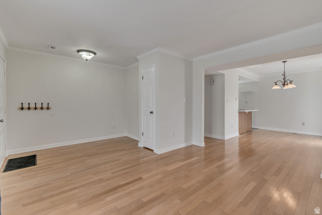 653 South 500 West, Unit 1 Provo, UT 84601 - Photo 5 of 17 Spacious room featuring light wood-finish flooring, white walls, and crown molding