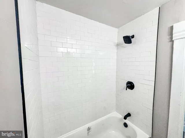a bathroom with a bathtub and shower