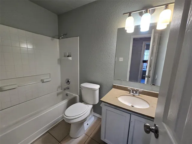 a bathroom with a sink a toilet a mirror and shower