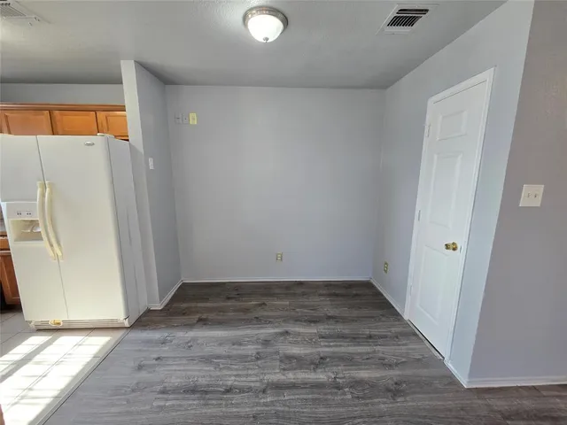 a view of a room with wooden floor and a window
