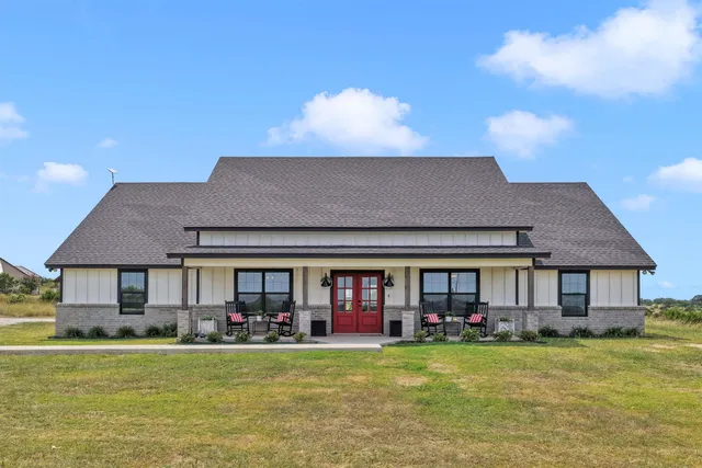 a front view of a house with swimming pool having outdoor seating