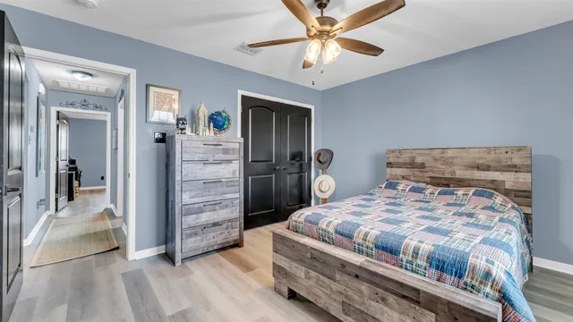 a bedroom with a bed and a chandelier