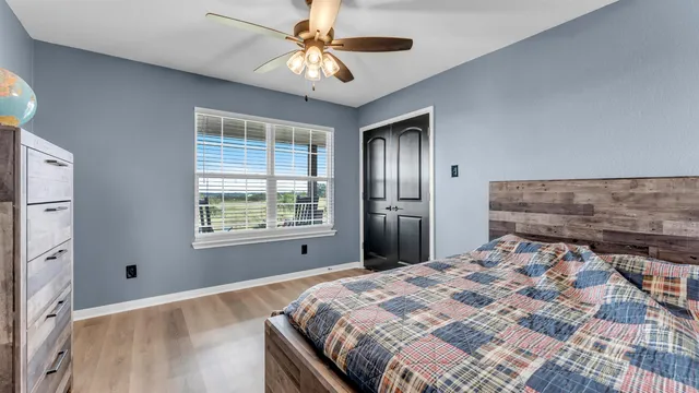 a bedroom with a bed and a chandelier