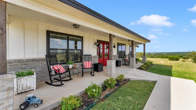 a view of a patio with chairs and a table