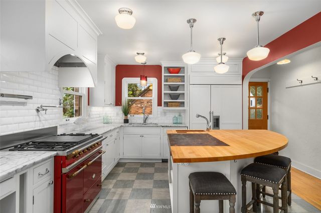a kitchen with granite countertop a stove and a sink