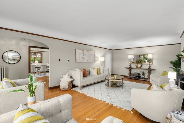 a living room with furniture and a large window with garden view