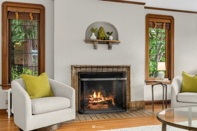 a living room with furniture two fireplace and a fireplace