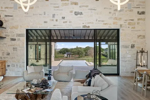 a living room with furniture a fireplace and a large window