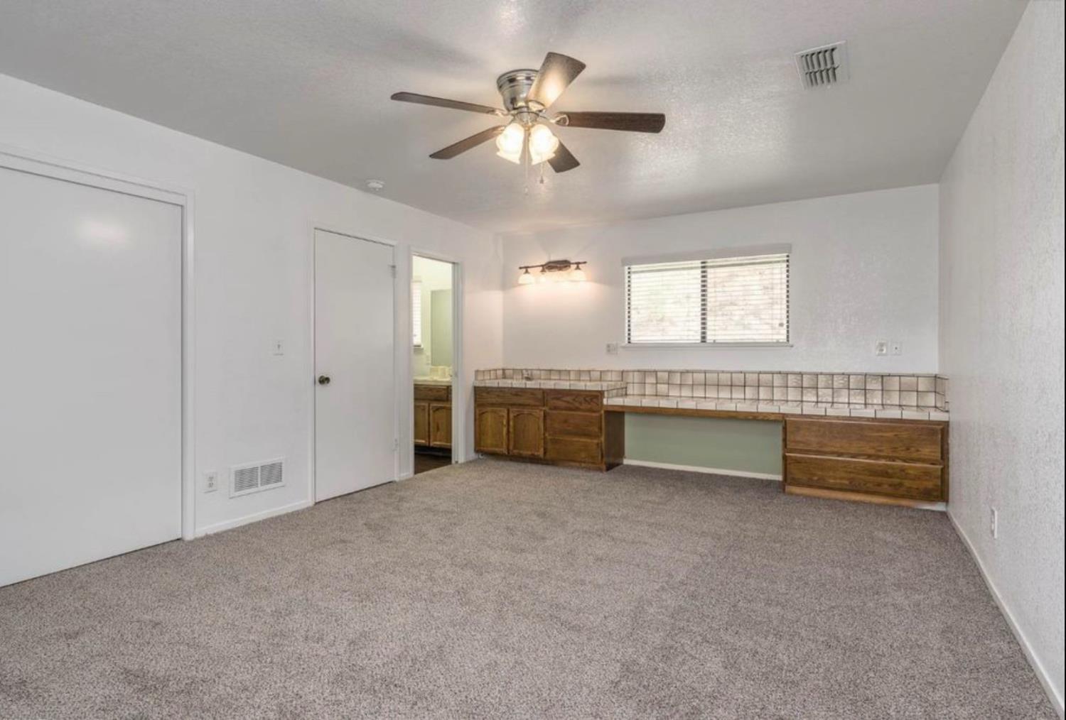 27817 Sky Harbour Road Friant, CA 93626 - Photo 16 of 36 a view of an empty room with a kitchen