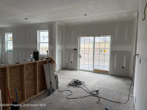 a view of a livingroom with wooden floor and a window
