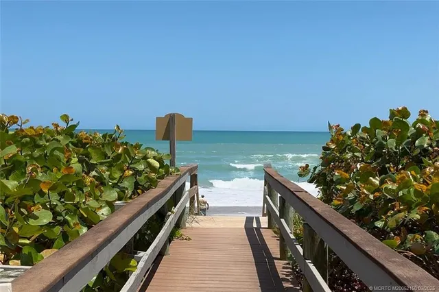 a balcony with wooden floor and city view