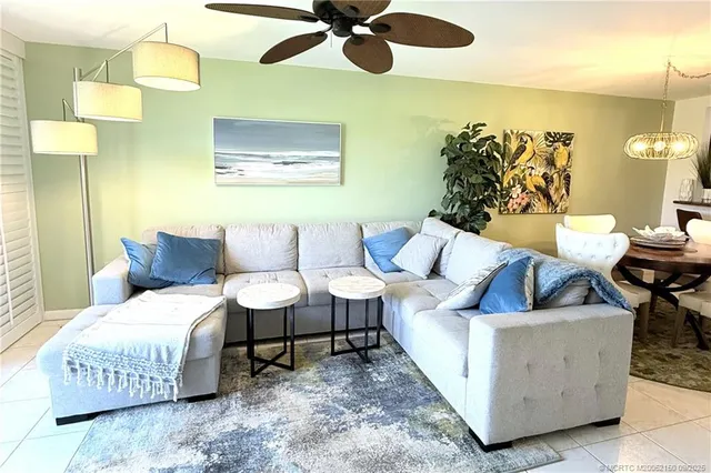 a living room with furniture and a lamp