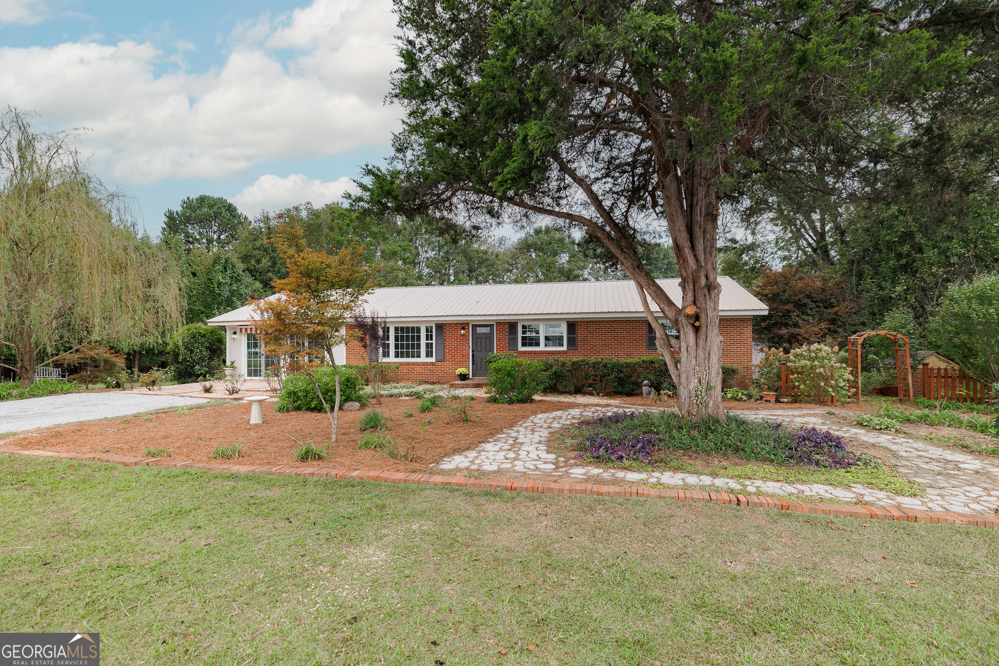 1471 Lenru Road Bogart, GA 30622 - Photo 1 of 1 a front view of a house with yard tree and wooden fence