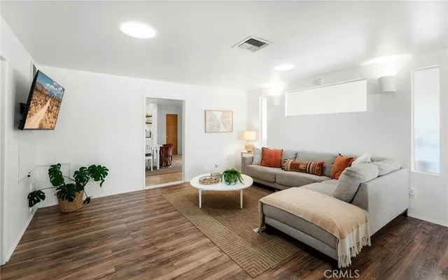 a living room with furniture fireplace and a large window