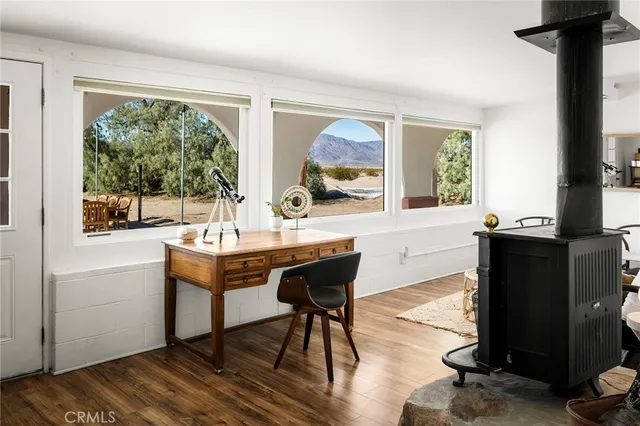 a dining room with furniture and wooden floor