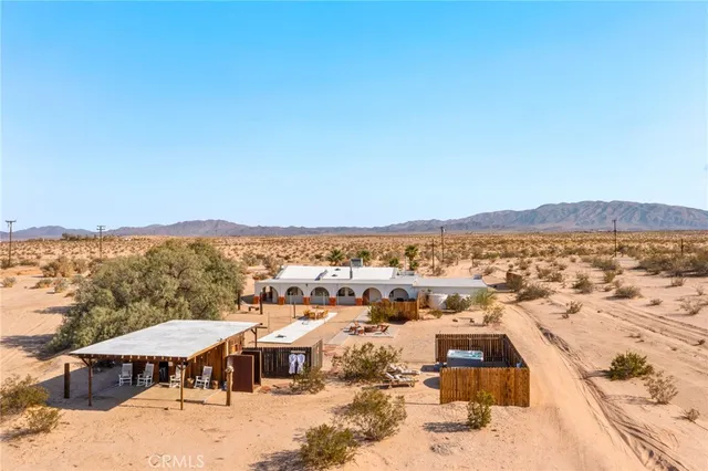 a dining area with stainless steel appliances kitchen island granite countertop a dining table chairs and a oven